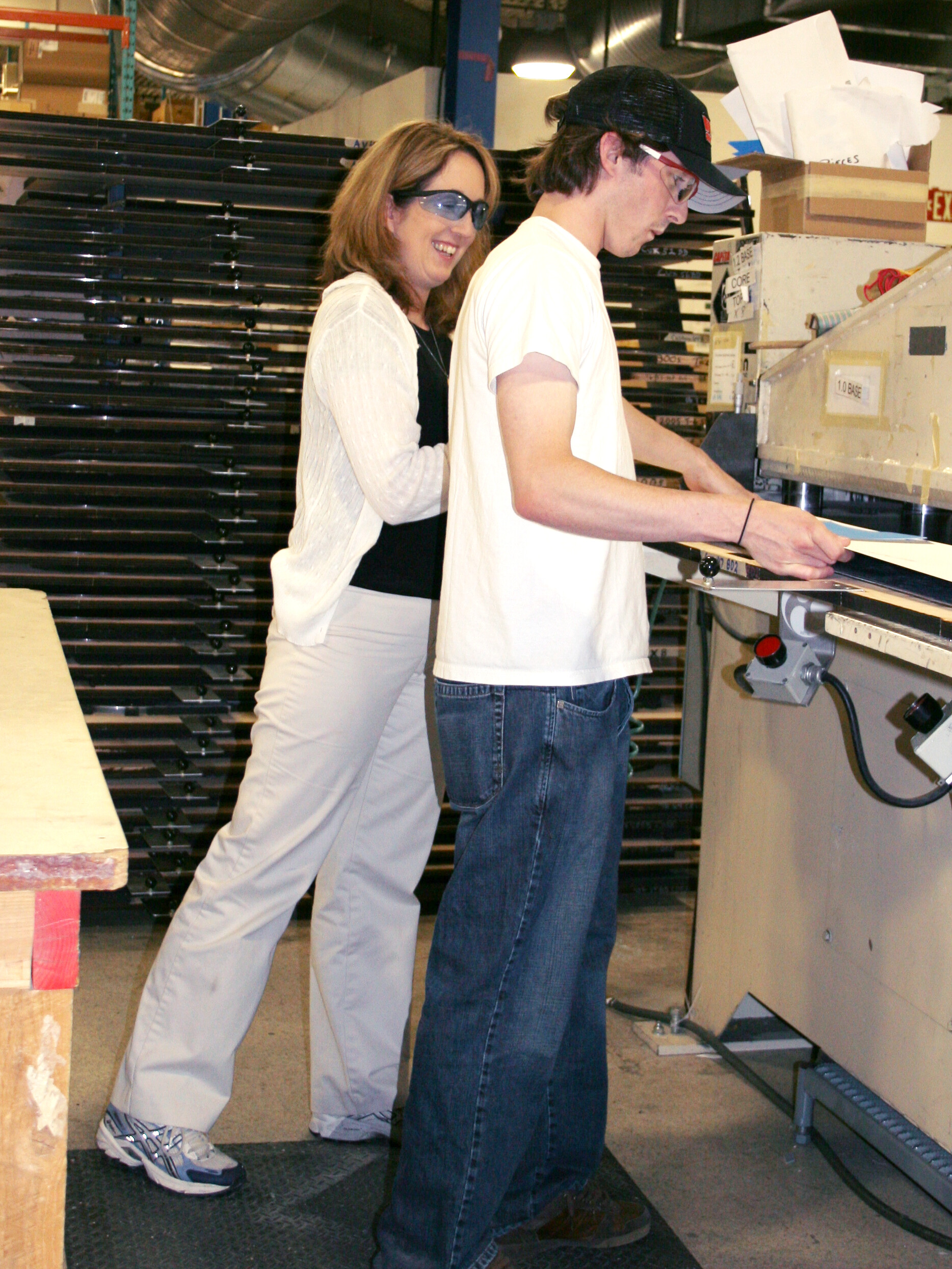 Louise showing an employee how to a workstation ergonomics